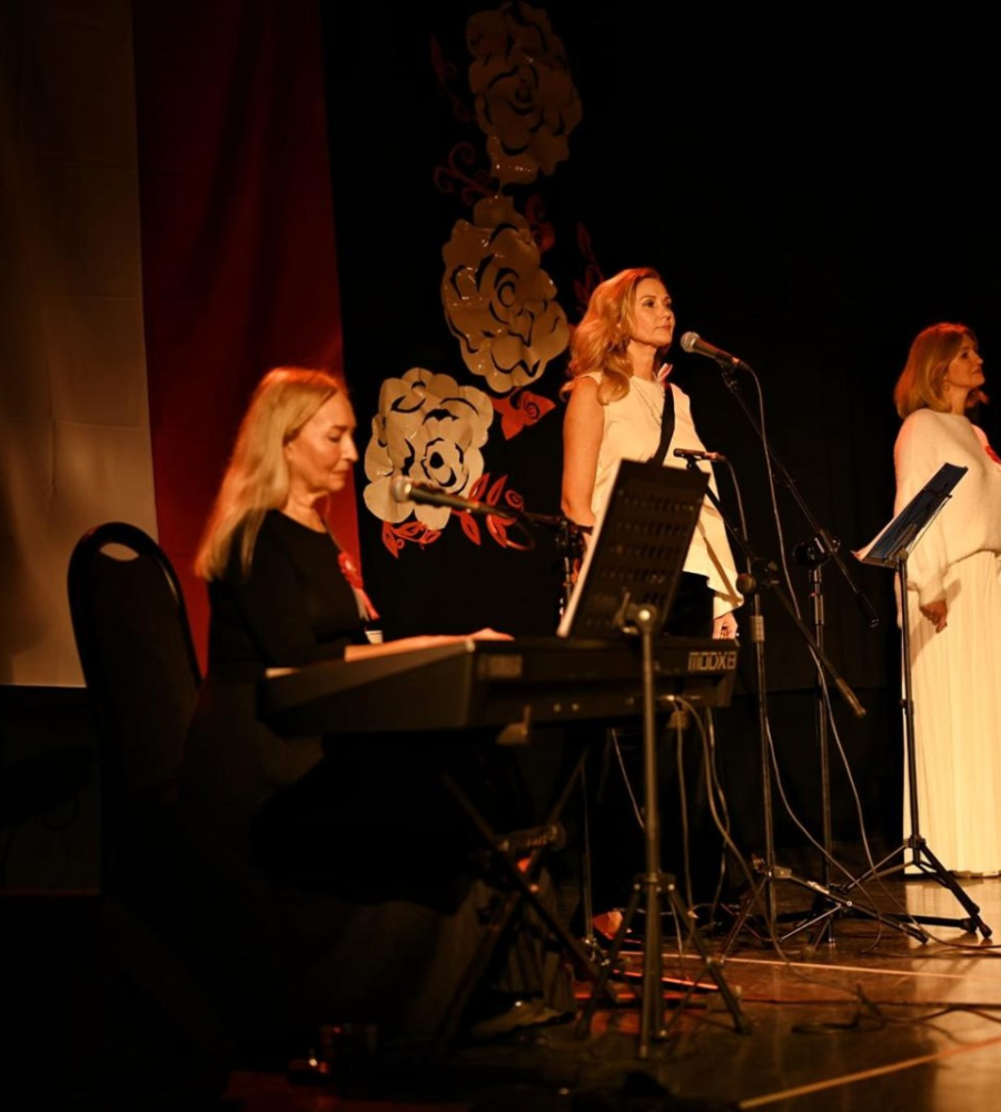 Trzy panie podczas wykonywania pieśni patriotycznych